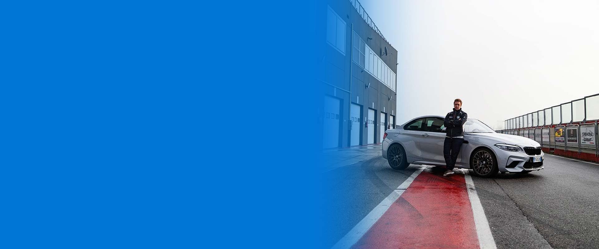 Davide Valsecchi a bordo pista accanto alla BMW M2 Competition